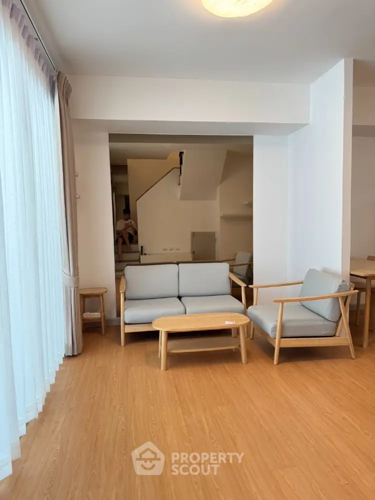 Spacious living room with modern furniture and wooden flooring