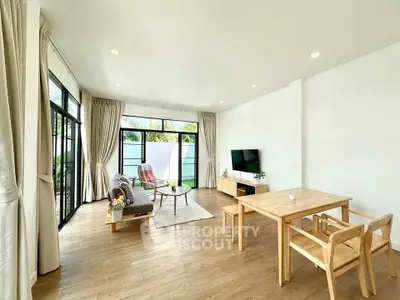 Bright and spacious living room with modern decor and large windows