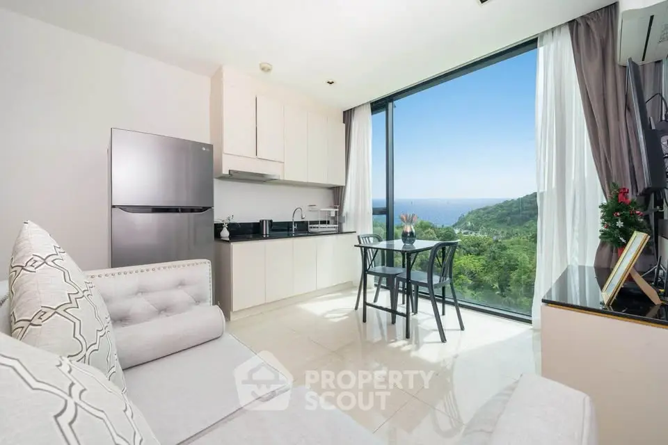 Modern living room with stunning ocean view and sleek kitchen area