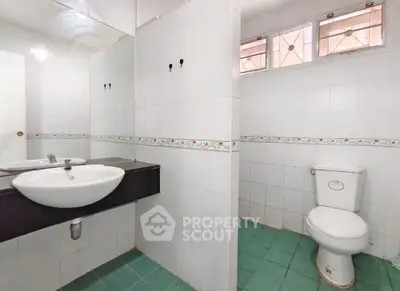 Spacious bathroom with modern fixtures and tiled flooring