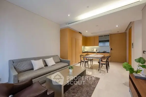 Modern living room with open kitchen layout and stylish furniture