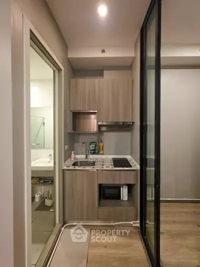 Compact modern kitchen with sleek cabinetry and built-in appliances