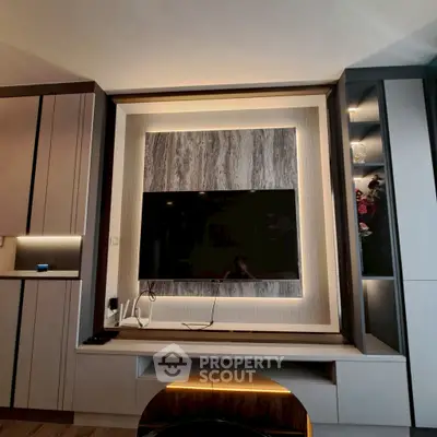 Modern living room with built-in TV and stylish cabinetry