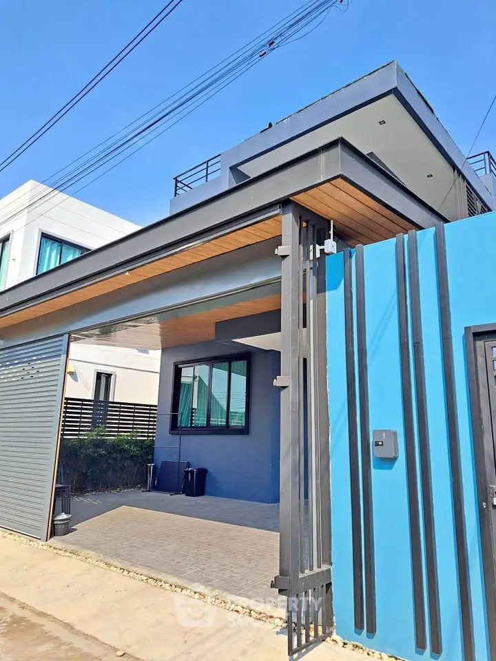 Modern architectural home exterior with sleek design and vibrant blue accents.