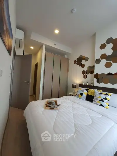 Modern bedroom with stylish decor and cozy ambiance in a contemporary apartment.