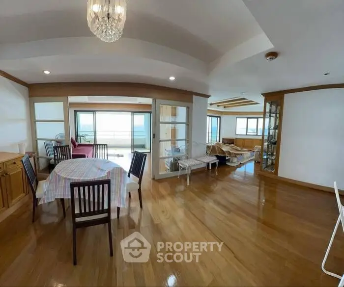 Spacious open-plan living and dining area with ocean view and elegant decor.