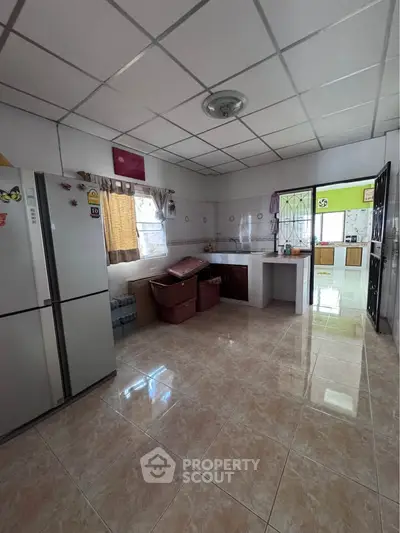 Spacious kitchen with modern appliances and open layout, perfect for culinary enthusiasts.
