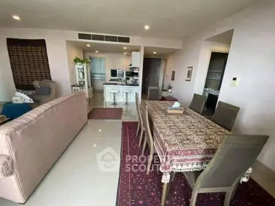 Spacious open-plan living and dining area with modern kitchen in elegant apartment.