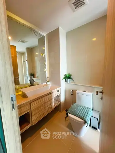 Modern bathroom with sleek fixtures and stylish vanity in a contemporary apartment.