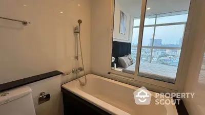 Modern bathroom with bathtub and city view through window