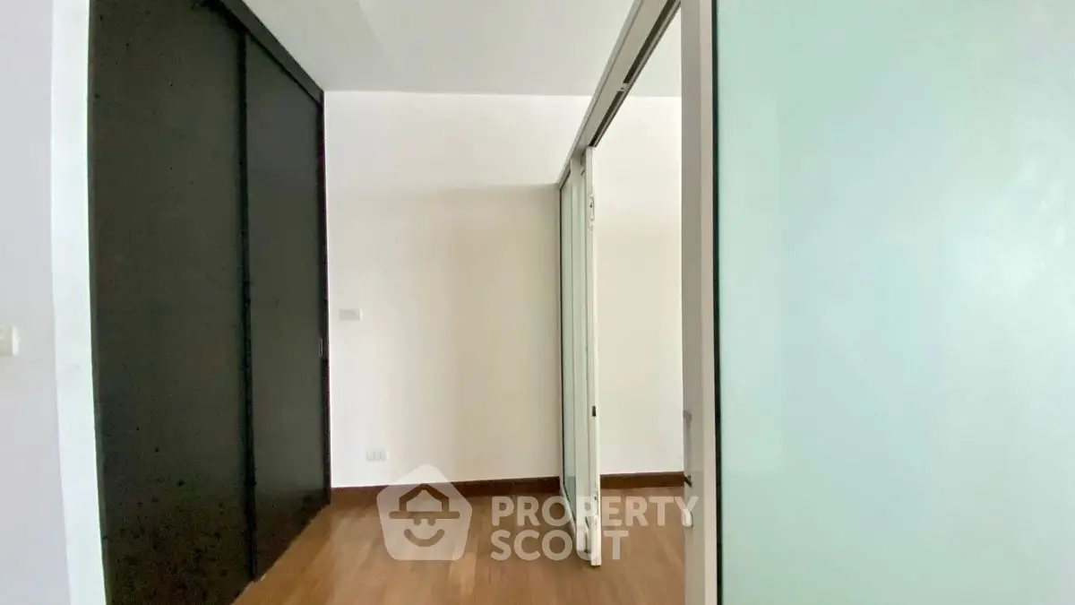 Spacious interior with sliding doors and wooden flooring