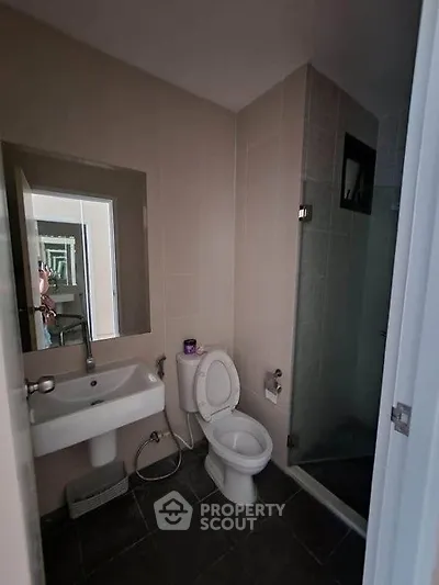 Modern bathroom with sleek fixtures and glass shower enclosure