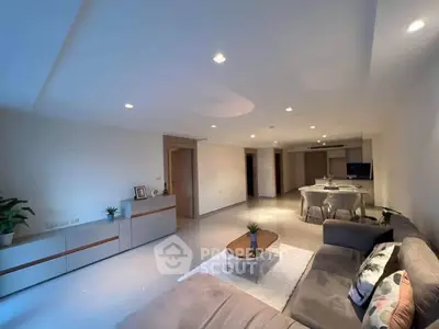 Spacious modern living room with elegant decor and ample natural light.