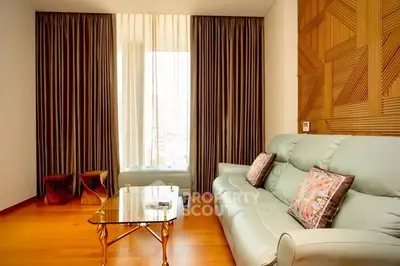 Elegant living room with modern decor and large windows