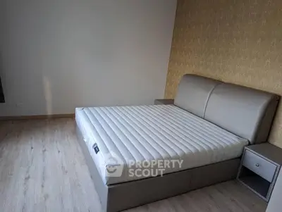 Modern bedroom with stylish bed and wooden flooring