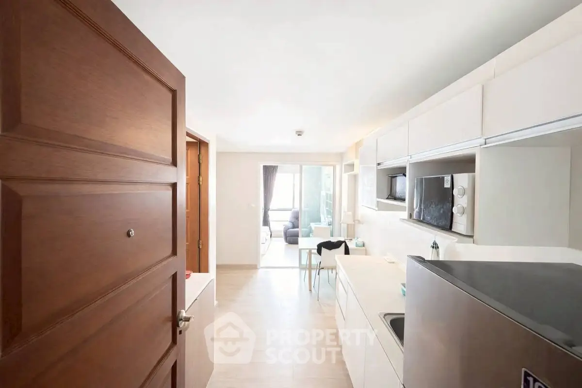 Modern open-layout kitchen with sleek appliances and bright living area view.