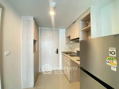 Modern kitchen with sleek cabinetry and stainless steel appliances in a compact layout.