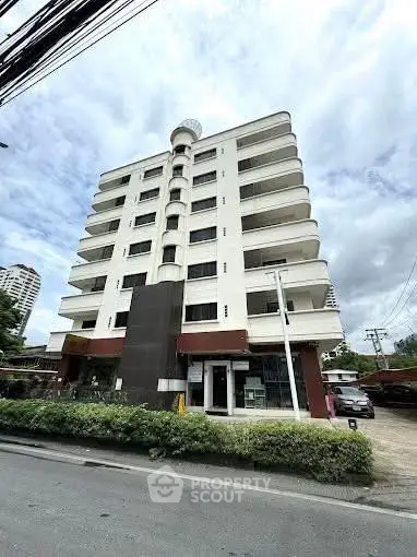 Modern multi-story building with spacious balconies and contemporary design.