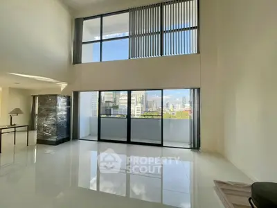 Spacious modern living room with large windows and city view