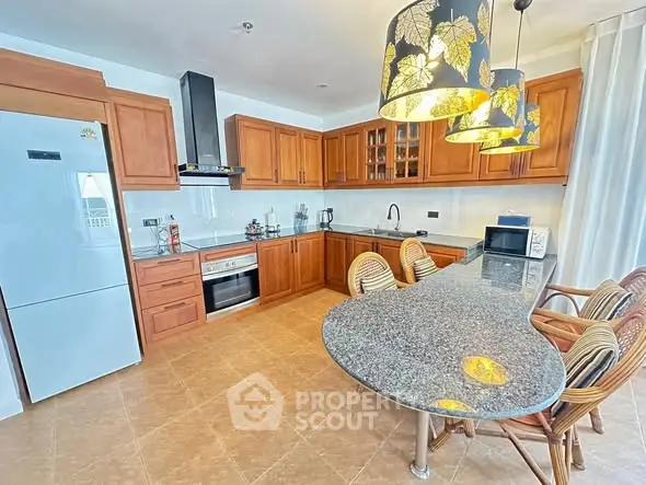 Spacious kitchen with wooden cabinets and modern appliances