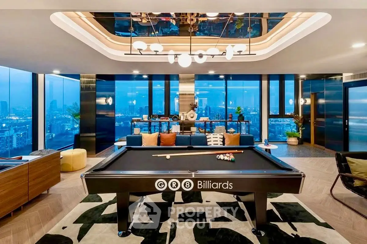 Luxurious penthouse living room with billiards table and stunning city skyline view.