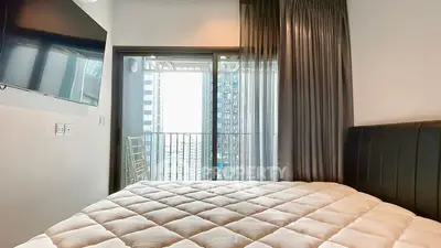 Modern bedroom with balcony view in urban apartment