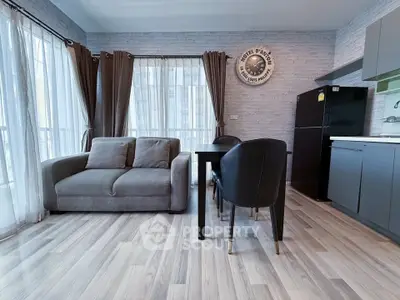 Modern living room with stylish decor and open kitchen layout in a bright apartment.