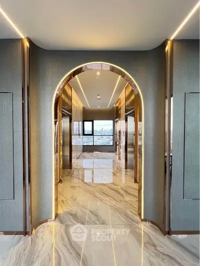 Luxurious building entrance with marble flooring and elegant lighting