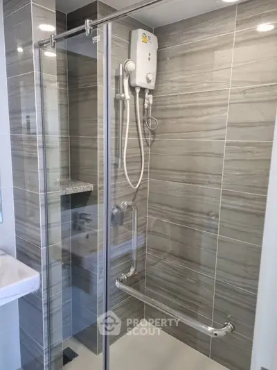 Modern bathroom with sleek shower enclosure and water heater