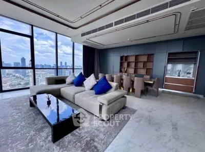 Luxurious living room with panoramic city views and modern furnishings in high-rise apartment.