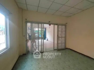 Spacious room with sliding glass doors leading to a patio, ideal for customization.