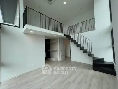 Modern duplex apartment with sleek staircase and high ceilings