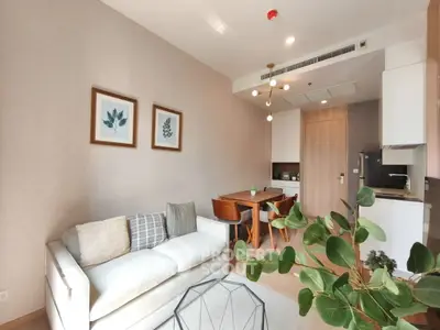 Modern living room with stylish decor and open kitchen layout in a contemporary apartment.
