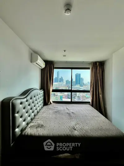 Spacious bedroom with city view and elegant bed in modern apartment