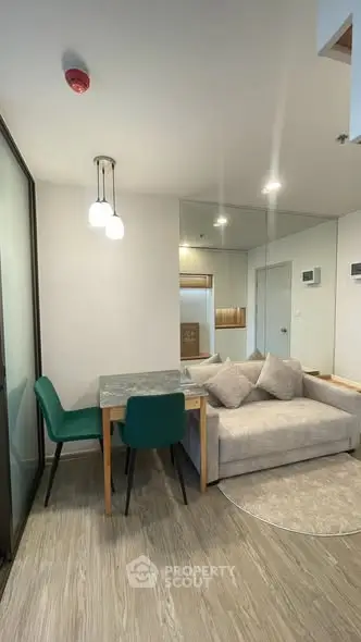 Modern living room with stylish furniture and elegant lighting in a cozy apartment.