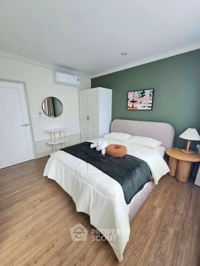 Modern bedroom with stylish decor and cozy ambiance, featuring a plush bed and elegant furnishings.