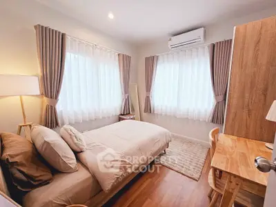 Cozy and bright bedroom with modern decor and ample natural light.