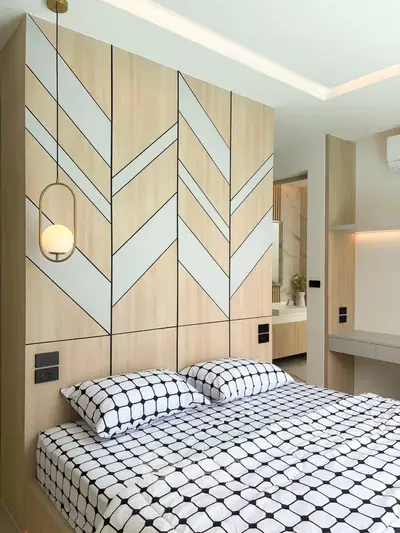 Modern bedroom with geometric wall design and stylish pendant lighting