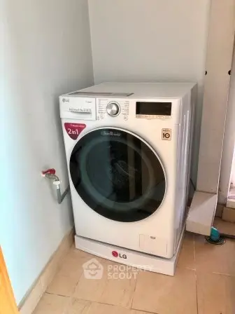 Modern laundry area with LG washing machine in a compact space.