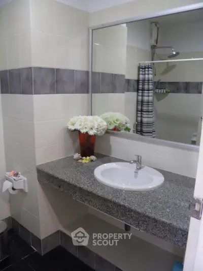 Modern bathroom with granite countertop and stylish decor