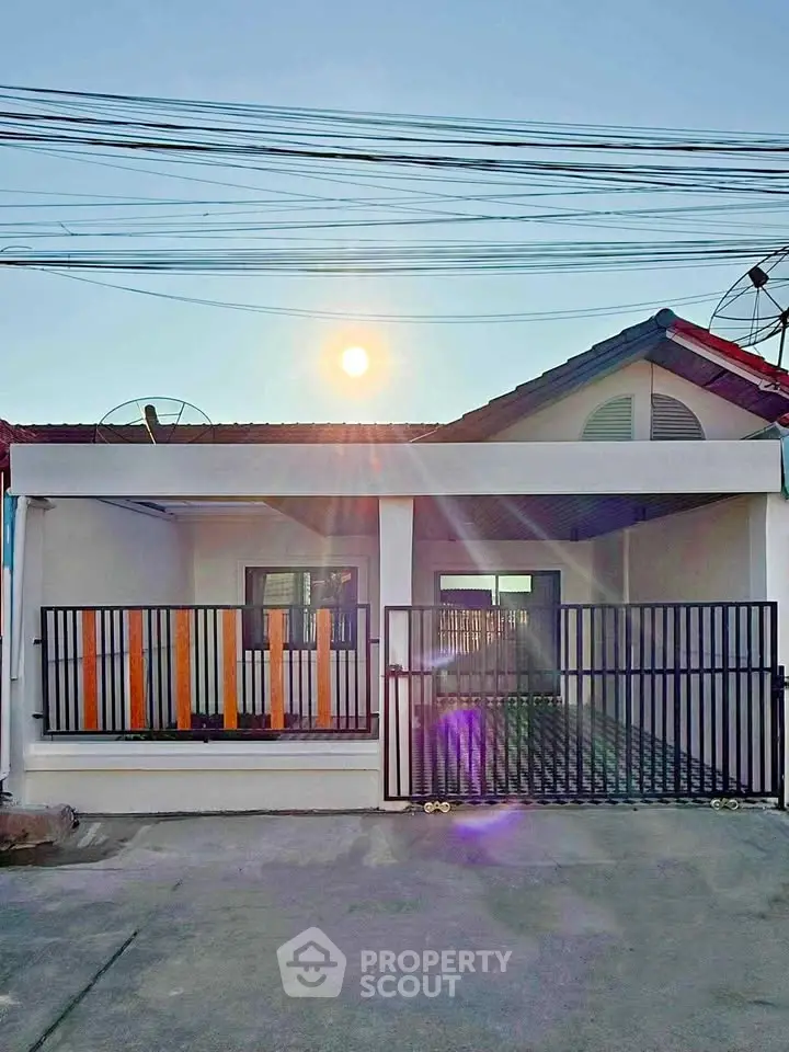 Charming single-story home with gated entrance and sunny facade, perfect for cozy living.