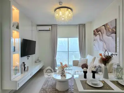 Elegant living room with modern decor, chandelier, and large window offering natural light.