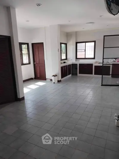 Spacious kitchen with closed layout and ample natural light