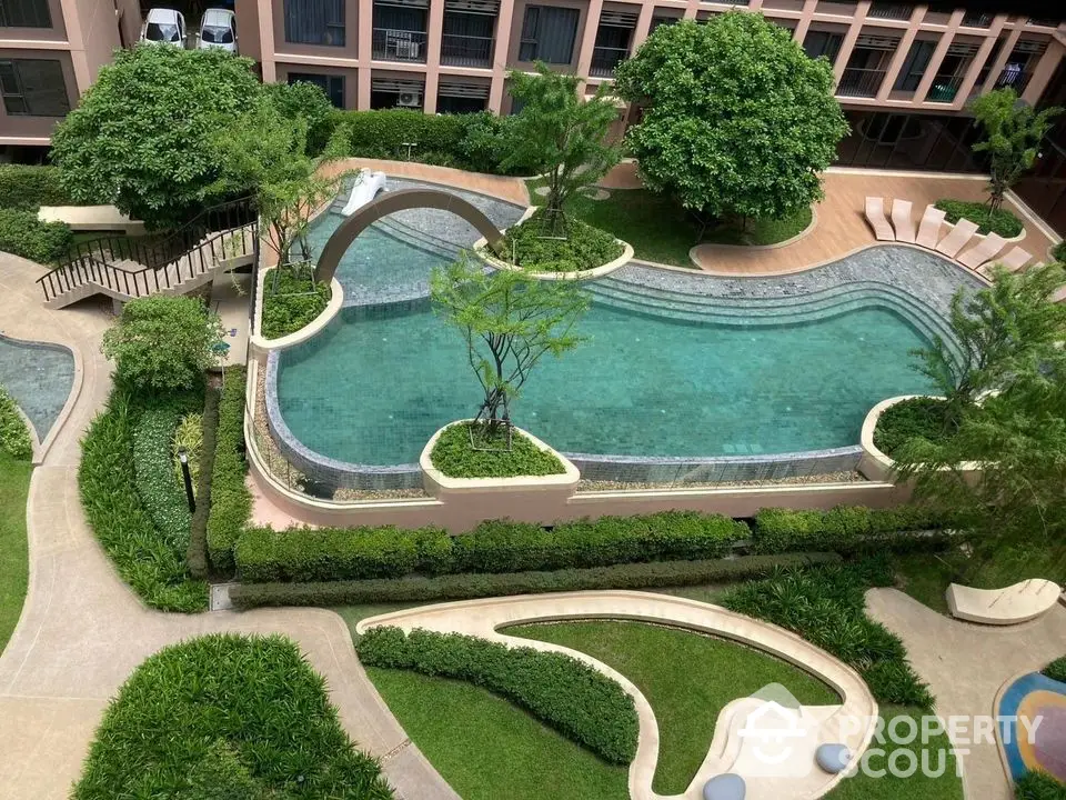 Luxurious apartment complex with stunning pool and lush gardens, perfect for relaxation and leisure.