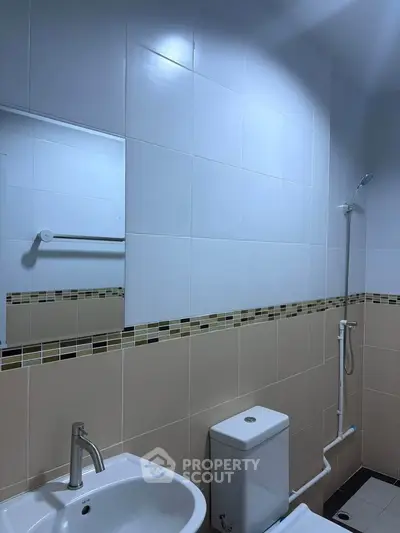 Modern bathroom with sleek fixtures and tiled walls