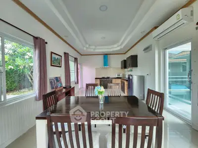 Spacious dining area with modern kitchen and garden view