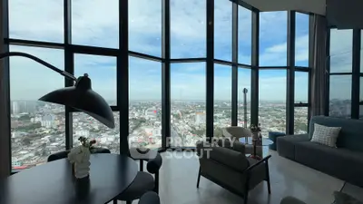 Stunning high-rise living room with panoramic city views and modern furnishings