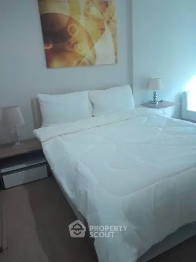 Cozy bedroom with modern decor and soft lighting, perfect for relaxation.