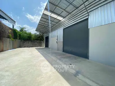 Spacious industrial warehouse with large roller door and ample outdoor space