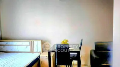 Cozy bedroom with modern furniture and small dining area, perfect for urban living.